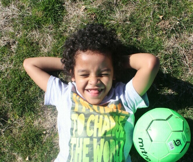 Child Daydreaming in a Field